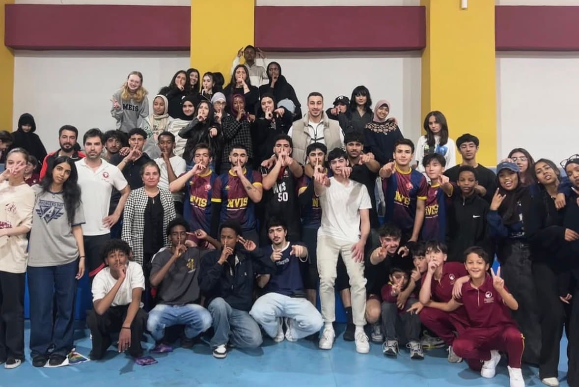 Students from many nationalities at a school assembly